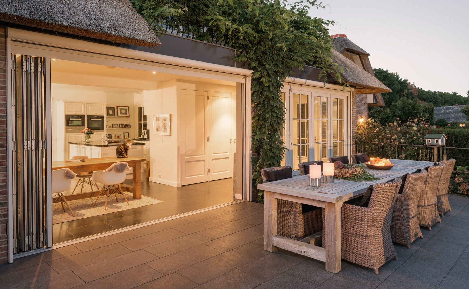 image of white bifolding doors in thatched cottage