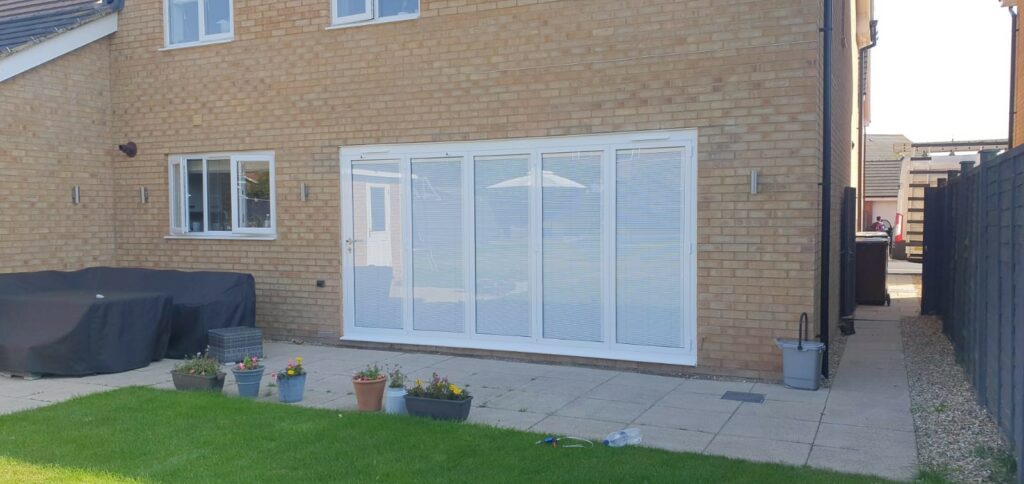 New build house with Origin slimline bifold doors and integral blinds in a closed position