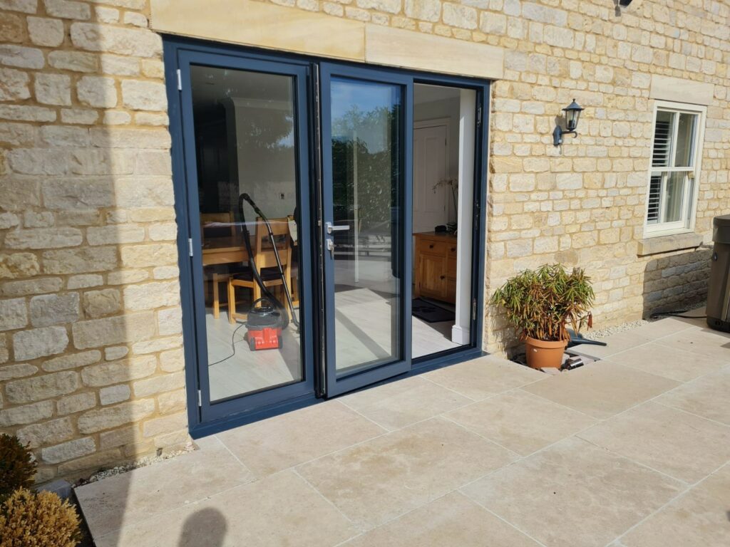 Schuco bifold doors in Cambridgeshire fitted in a stone aperture and in a grey colour