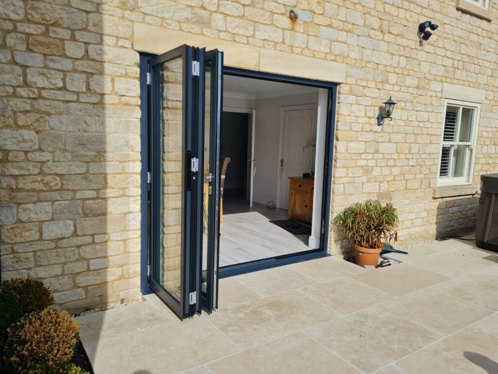 Schuco bifold doors in Cambridgeshire shown fully open on the patio