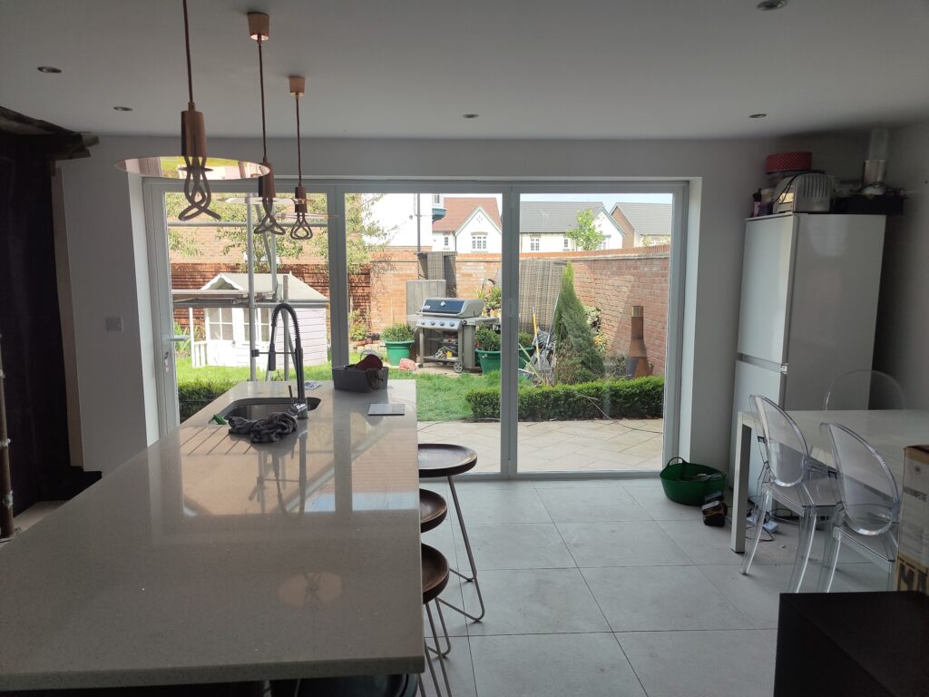 Origin slim doors in white in a new kitchen with garden views